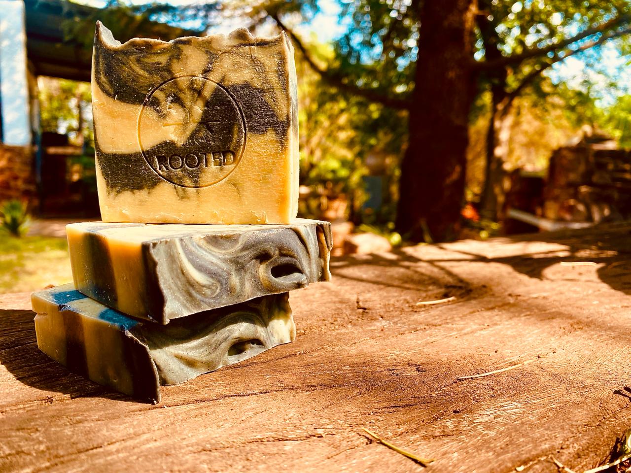 Rooted Ylang Tea-Tree Soap: handmade cream and charcoal swirl bars with the Rooted stamp